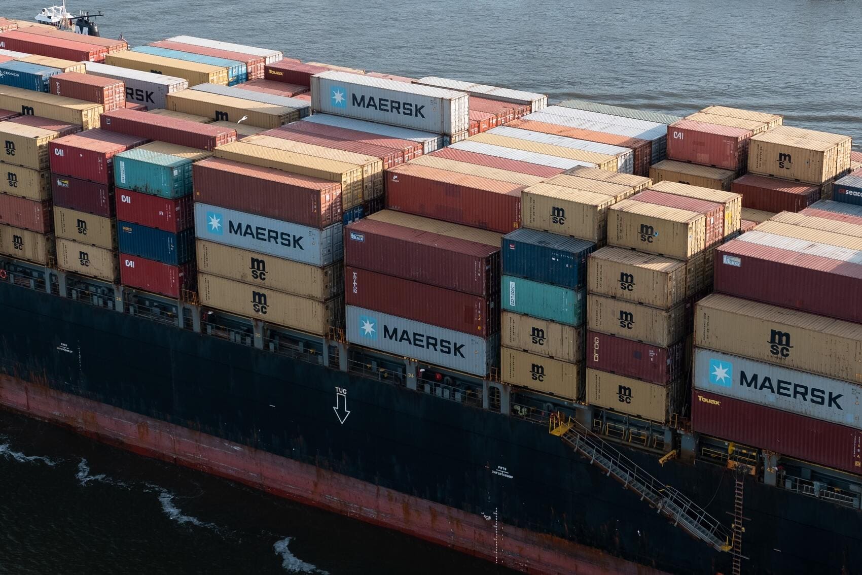 A large cargo ship with many containers on it.