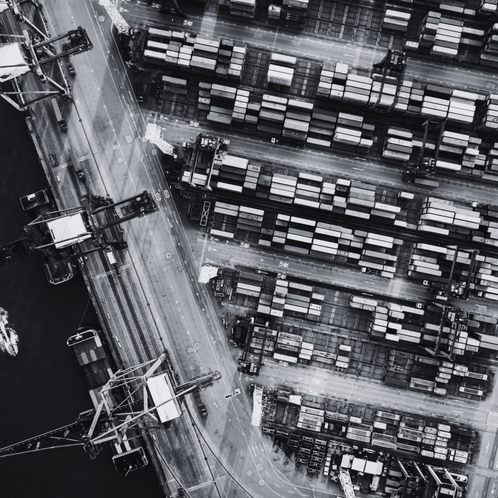 A black and white aerial photo of a harbor.