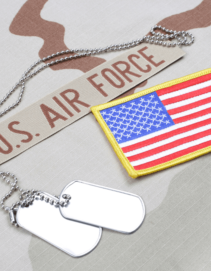 A u. S. Air force patch and dog tags on top of the table