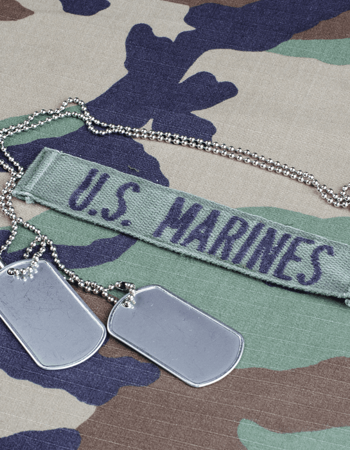 A us marine 's uniform with dog tags and a u. S. Marines tag