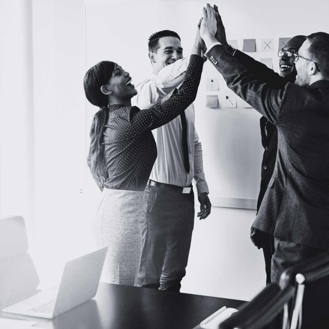 A group of people giving each other a high five.